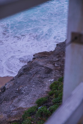 Gray Rocky Cliff Beside Beach Waves