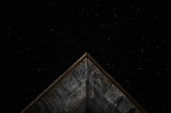 gray roof under starry sky at nighttime