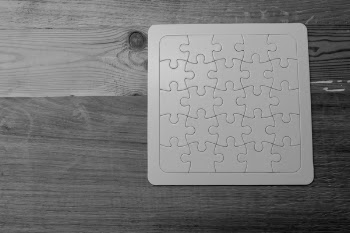Gray Scale Photo of Jigsaw Puzzle
