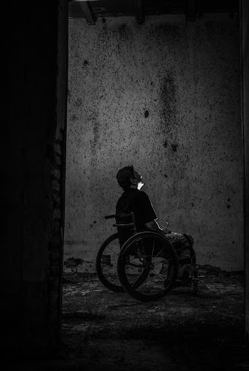 Gray scale Photo of Man Sitting on Wheelchair 