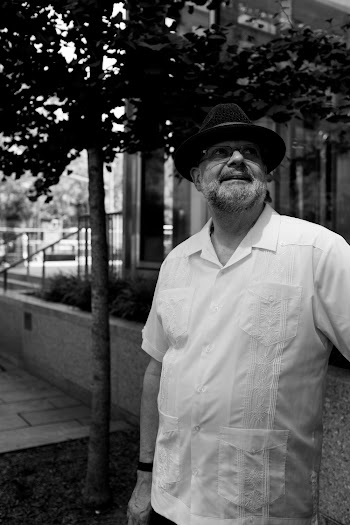 Gray-scale Photo of  Man Wearing Hat