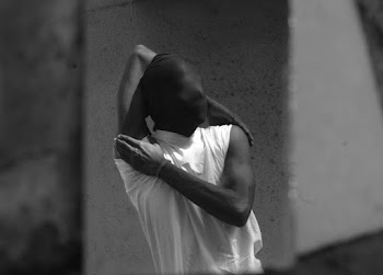 Gray scale Photo of Person in Sleeveless T-shirt and Covered Face