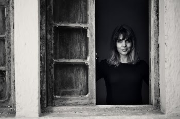 Gray Scale Photo of Woman in Window