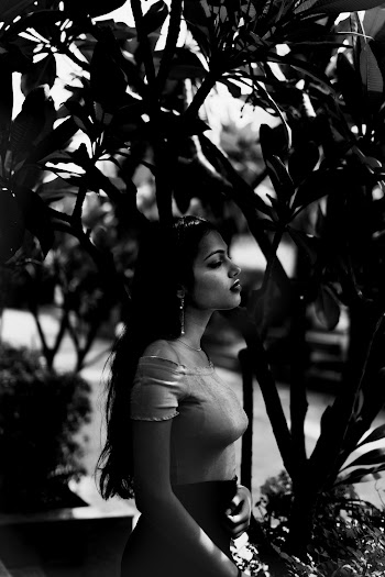 Gray-scale Photo of Woman Standing Near Trees