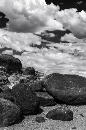 Gray Scale Photo Rocks and Clouds