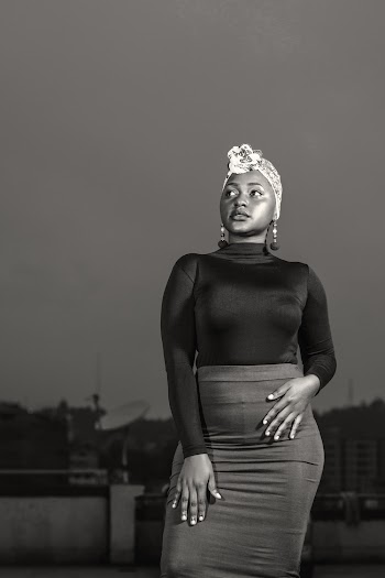 Gray scale photography of a woman wearing long sleeved top and skirt
