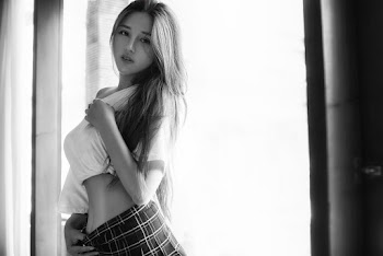 Gray scale photography of a woman wearing white crop top 