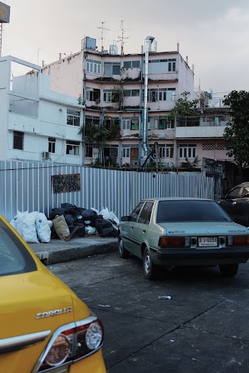 Gray Sedan Parked Beside Another Vehicle