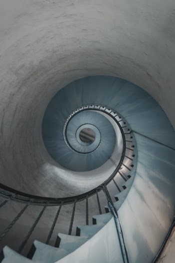 Gray Spiral Staircase With Black Metal Railings · Free Stock Photo
