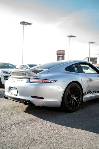 gray sports car parked on concrete pavement