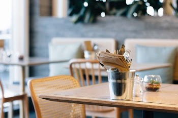 gray stainless steel cup with tissue on brown table