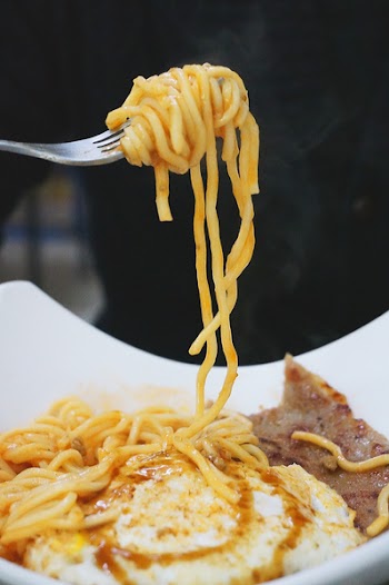 Gray Steel Fork With Yellow Pasta