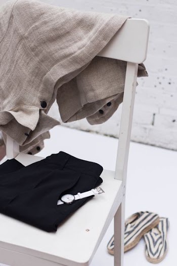 gray textile hanging on white wooden chair