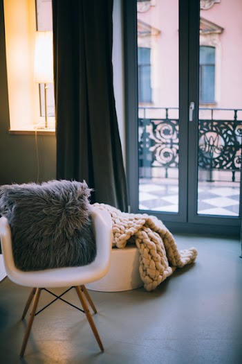Gray Throw Pillow on White Padded Armchair