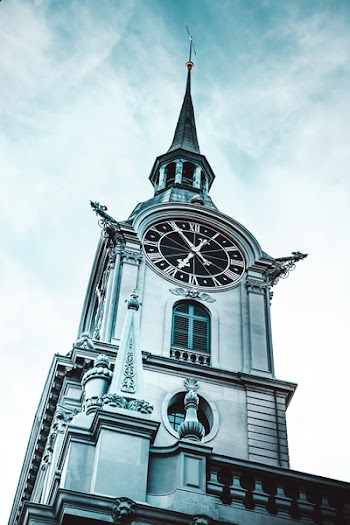 Gray Tower Clock Strikes 6:50 at during Day