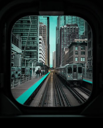Gray Train in Between of Buildings