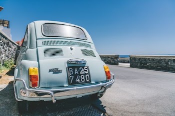 gray Volkswagen Beetle on gray concrete road