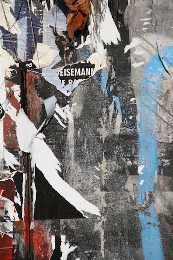 gray wall with flyers residues