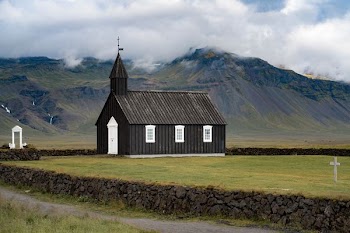 gray wooden church near mountain