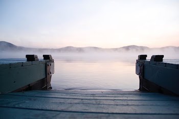 gray wooden dock near body of water