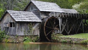 Gray Wooden House With Water Mill Surrounded by Trees