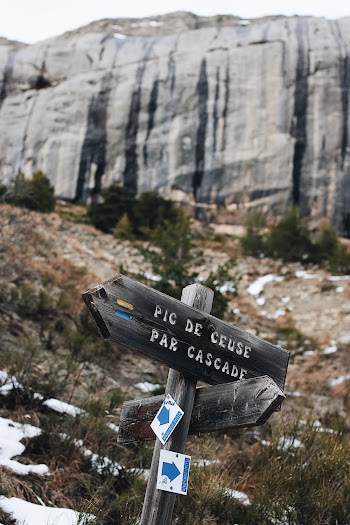 Gray Wooden Sign Beside Mountian