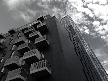 Grayscale and Low Angle Photography of High-rise Building Structure