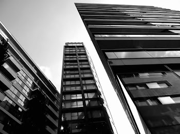 Grayscale and Low Angle Photography of High-rise Buildings