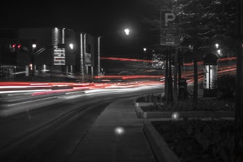 Grayscale and Time Lapse Photo of Vehicle at Night Time