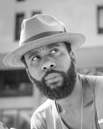 Grayscale Close-up Photo of Bearded Man in Hat Looking Away