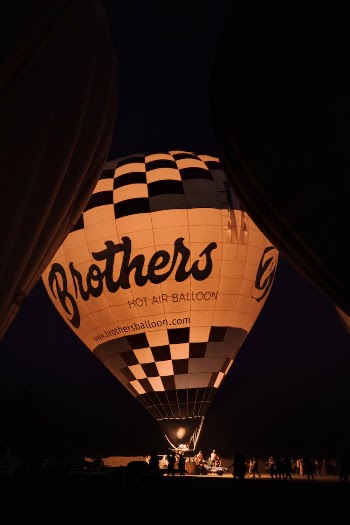 Grayscale Photo of a Hot Air Balloon at Night