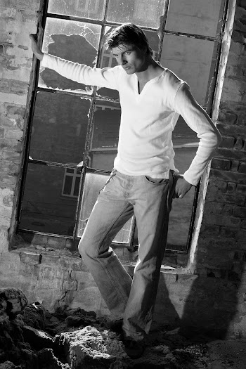 Grayscale Photo Of A Male Model By A Broken Window
