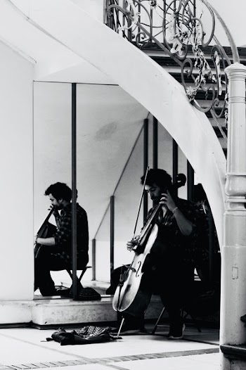 Grayscale Photo of a Man Playing Cello
