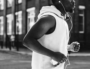 Grayscale Photo Of A Man Running 