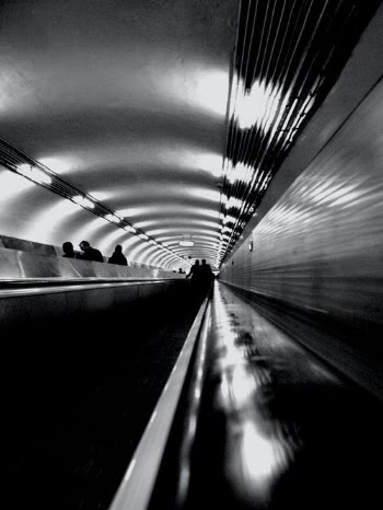 Grayscale Photo of a Man Walking on a Tunnel · Free Stock Photo