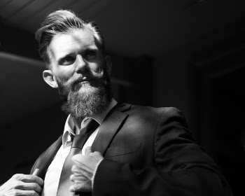 Grayscale Photo of a Man Wearing Coat