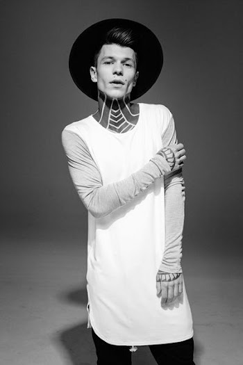 grayscale photo of a man wearing gray long-sleeved shirt