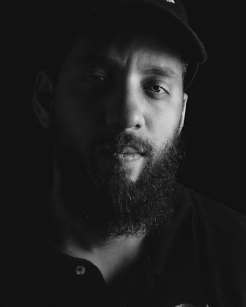 Grayscale Photo of a Man With a Beard