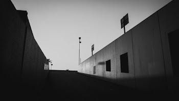 Grayscale Photo Of A Road Between Two Walls
