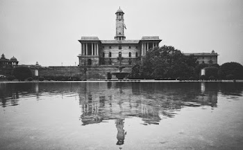 Grayscale Photo of a Structure Near Body of Water