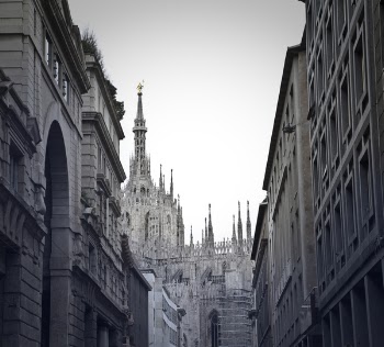Grayscale Photo of Alley With Tower Background