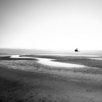 Grayscale Photo of Boat On Body Of Water