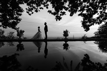 Grayscale Photo of Bride and Groom Facing Each Other Standing by Body of Water