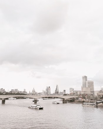 Grayscale Photo of Bridge Near White Boat