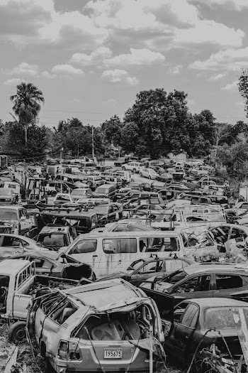 Grayscale Photo Of Broken Vehicles