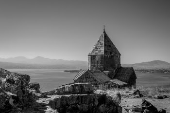 Grayscale Photo of Building Near Body of Water