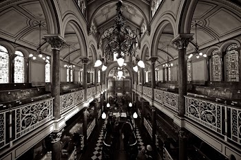 Grayscale Photo of Chandelier over Black Table