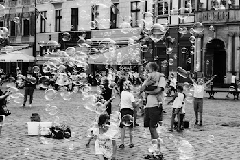 Grayscale Photo of Children and Parents Outdoors With Bubbles