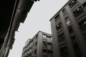 Grayscale Photo of Concrete Buildings