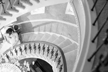 Grayscale Photo of Couple Standing on Stairs